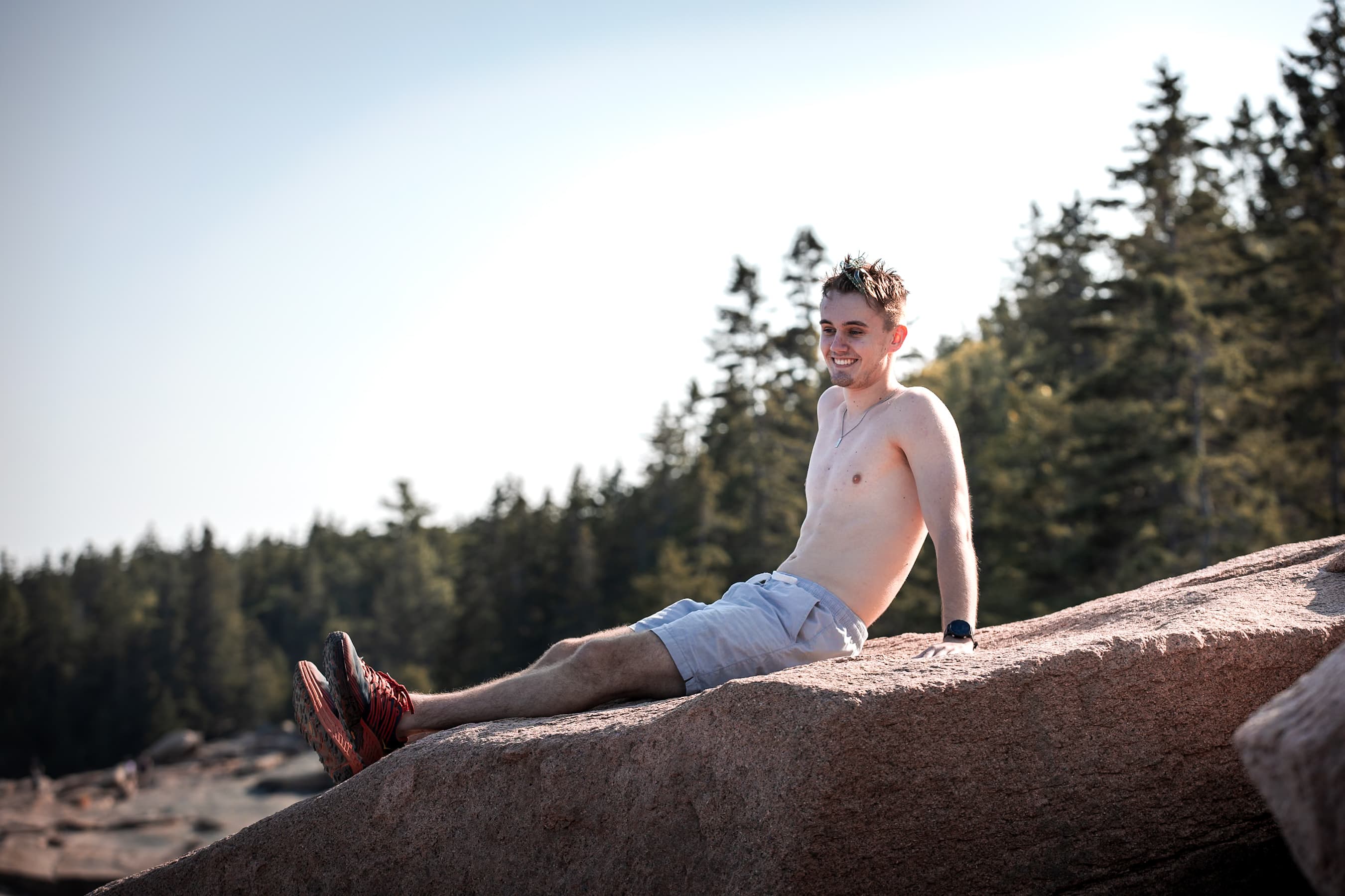 Man relaxing on rock at golden hour